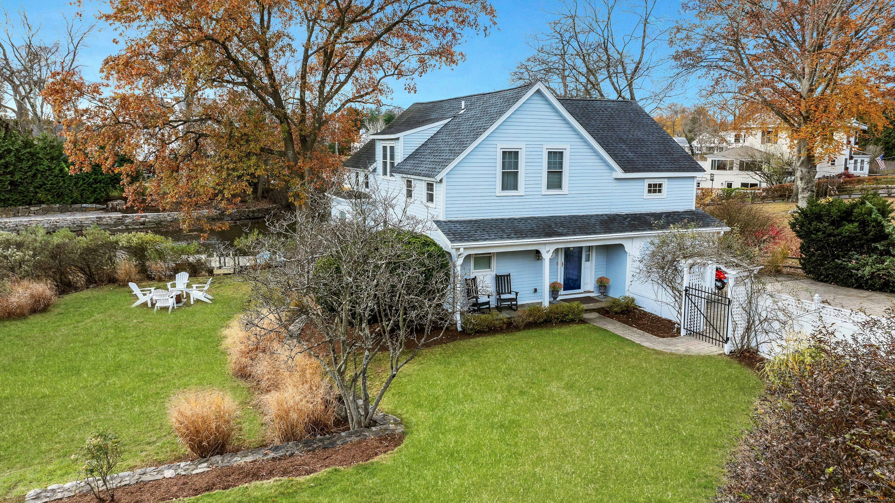 209 Rowayton Avenue Norwalk, CT 06853 - Photo 4 of 26 a view of a house with a yard patio and fire pit