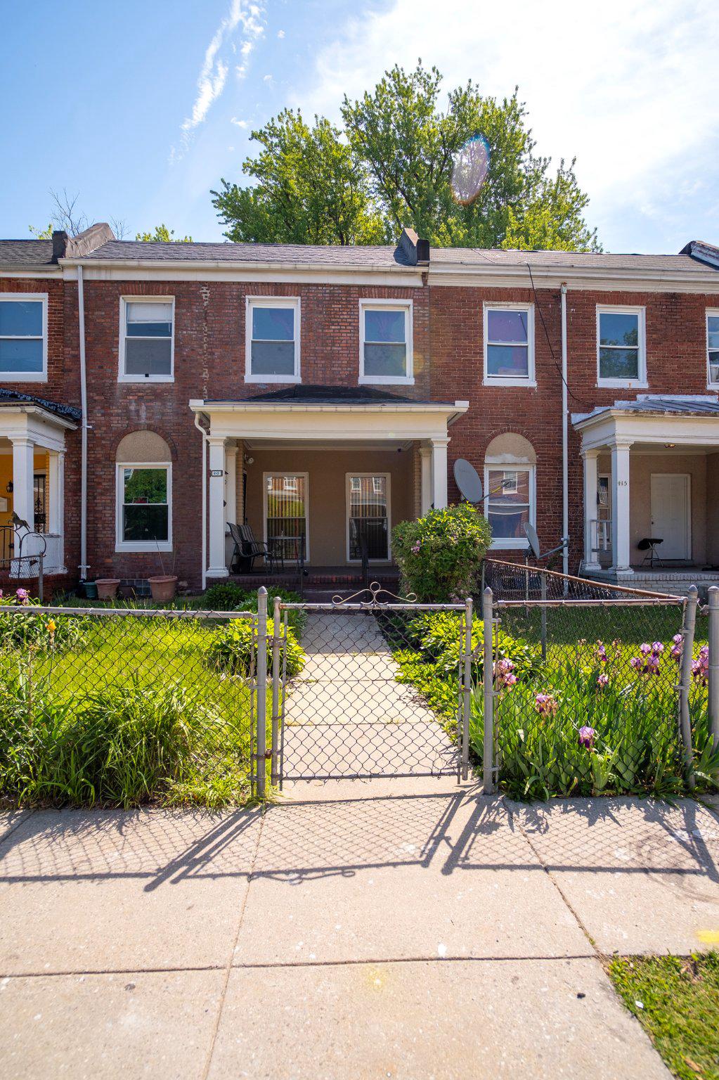 413 Rosecroft Terrace Baltimore, MD 21229 - Photo 1 of 21 a front view of a house with garden