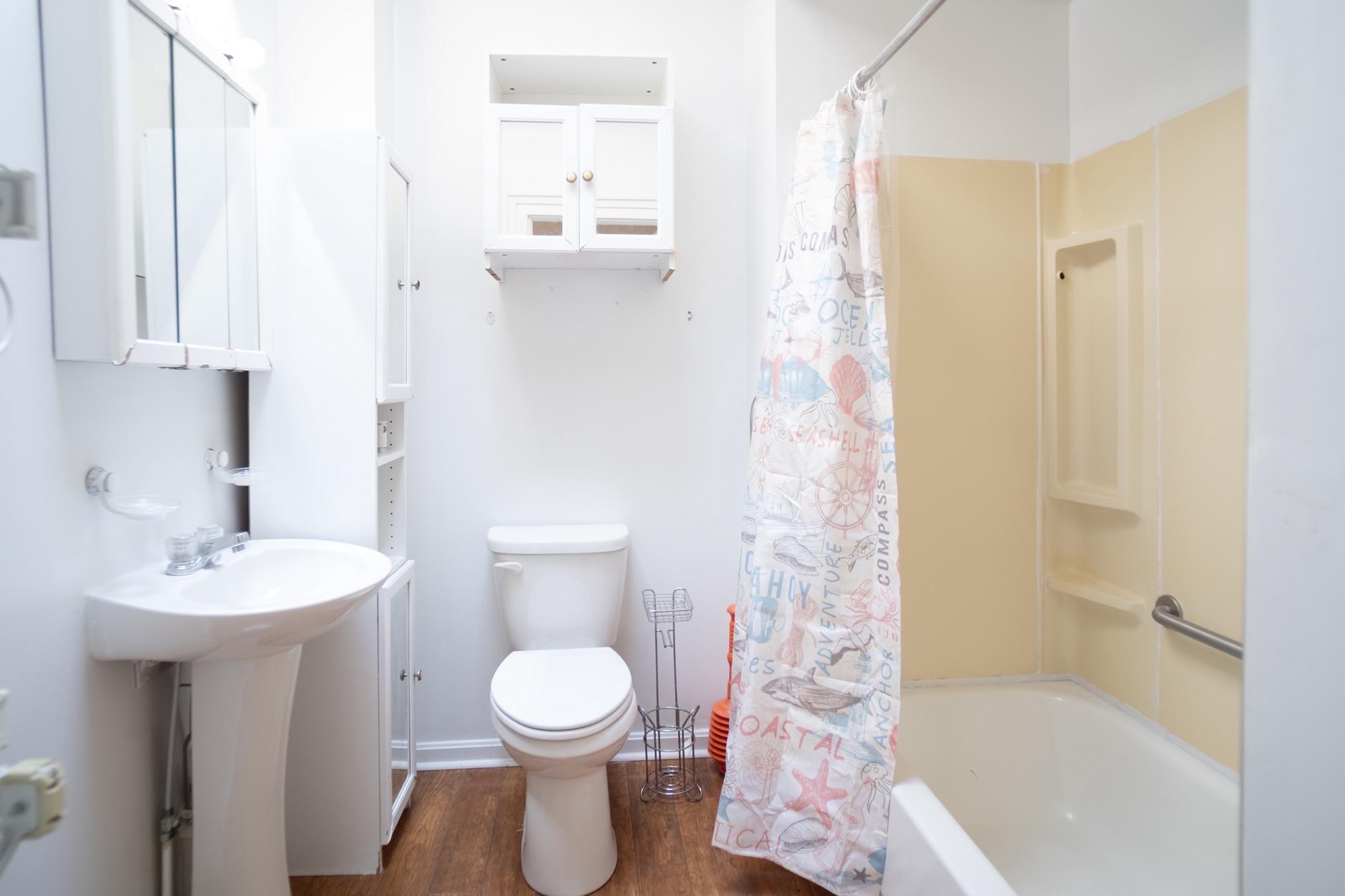 413 Rosecroft Terrace Baltimore, MD 21229 - Photo 15 of 21 a bathroom with a sink a toilet and shower
