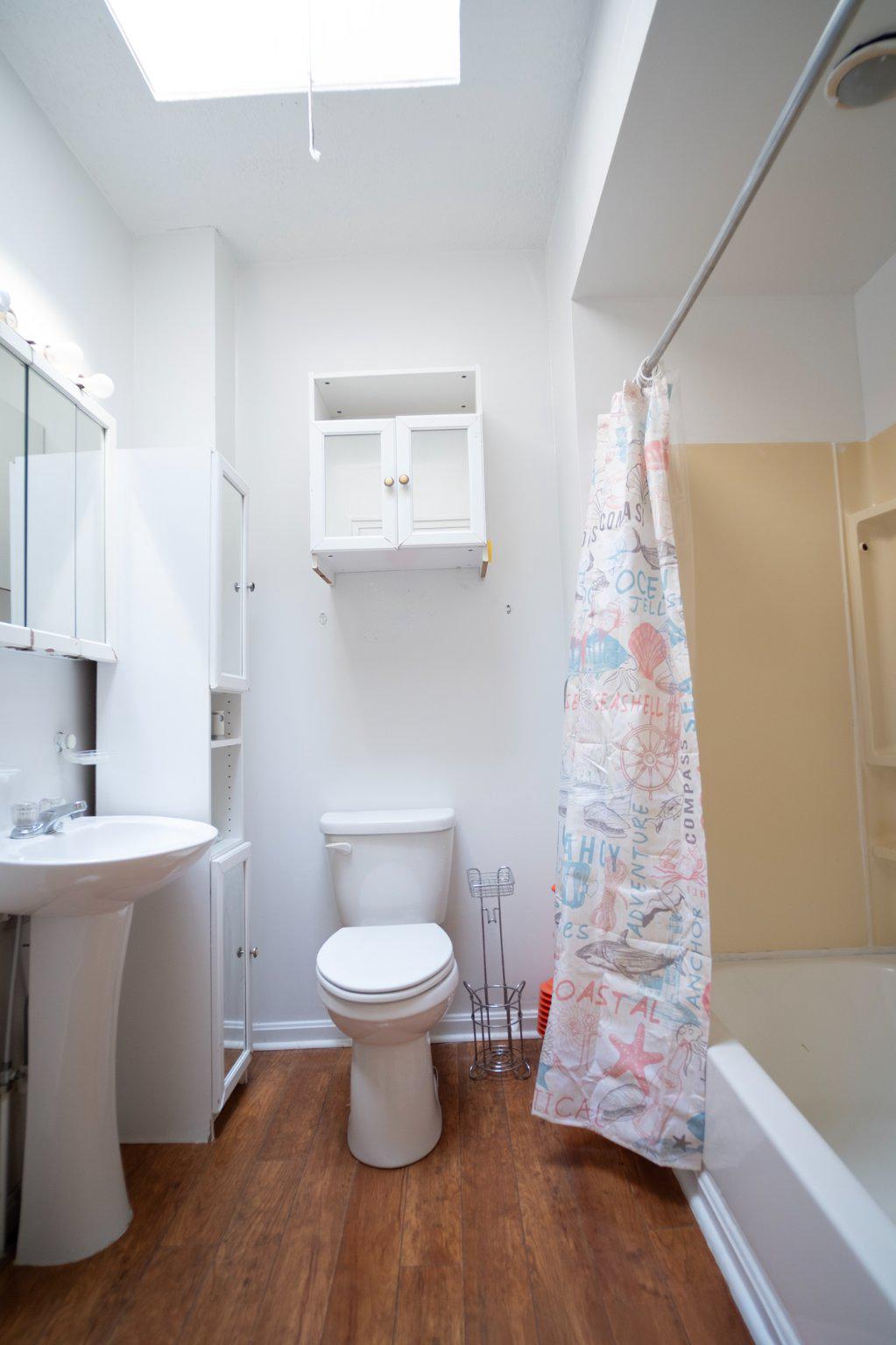 413 Rosecroft Terrace Baltimore, MD 21229 - Photo 16 of 21 a bathroom with a sink toilet and shower