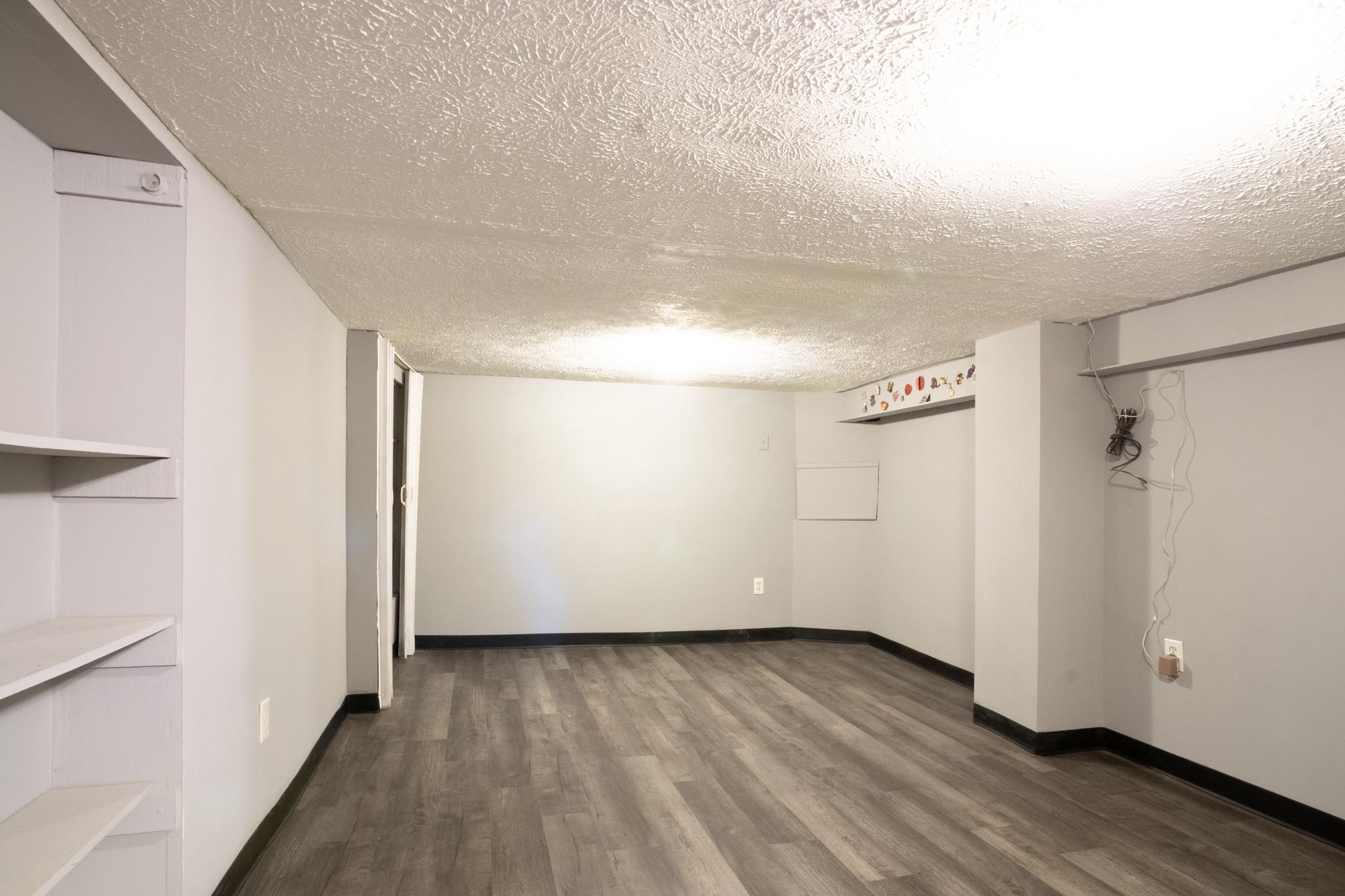 413 Rosecroft Terrace Baltimore, MD 21229 - Photo 17 of 21 a view of an empty room with wooden floor and a window