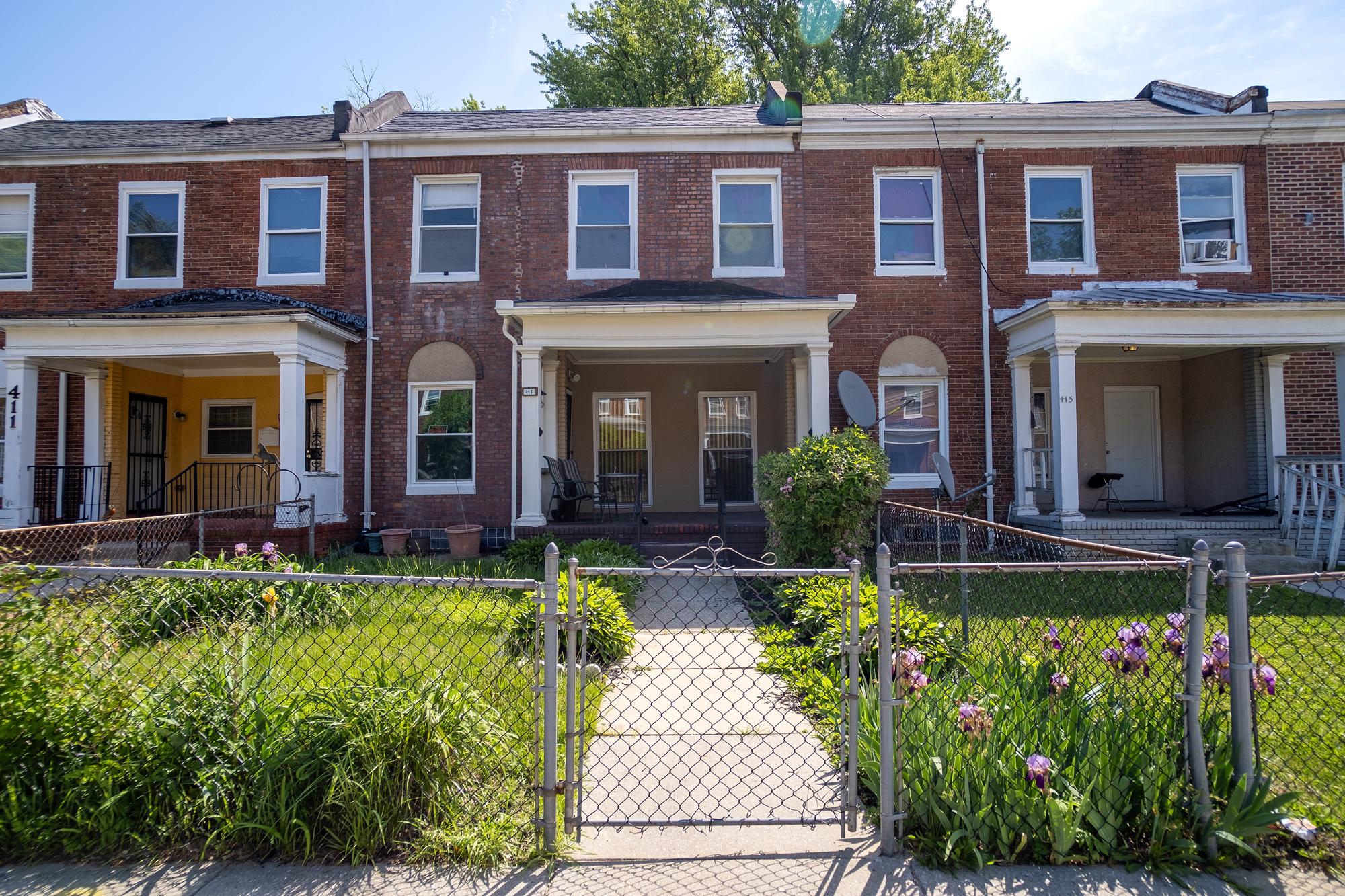 413 Rosecroft Terrace Baltimore, MD 21229 - Photo 2 of 21 a front view of a house with yard and outdoor seating