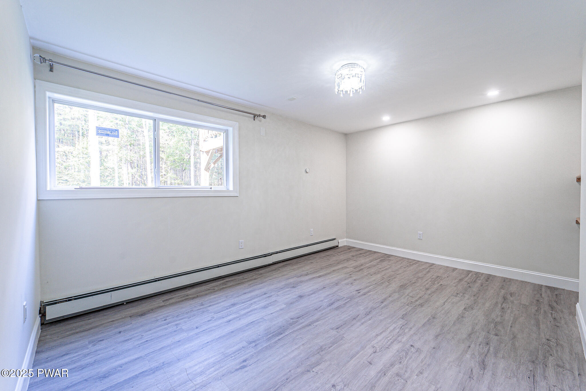 153 Hatton Road Hawley, PA 18428 - Photo 24 of 38 an empty room with wooden floor and windows