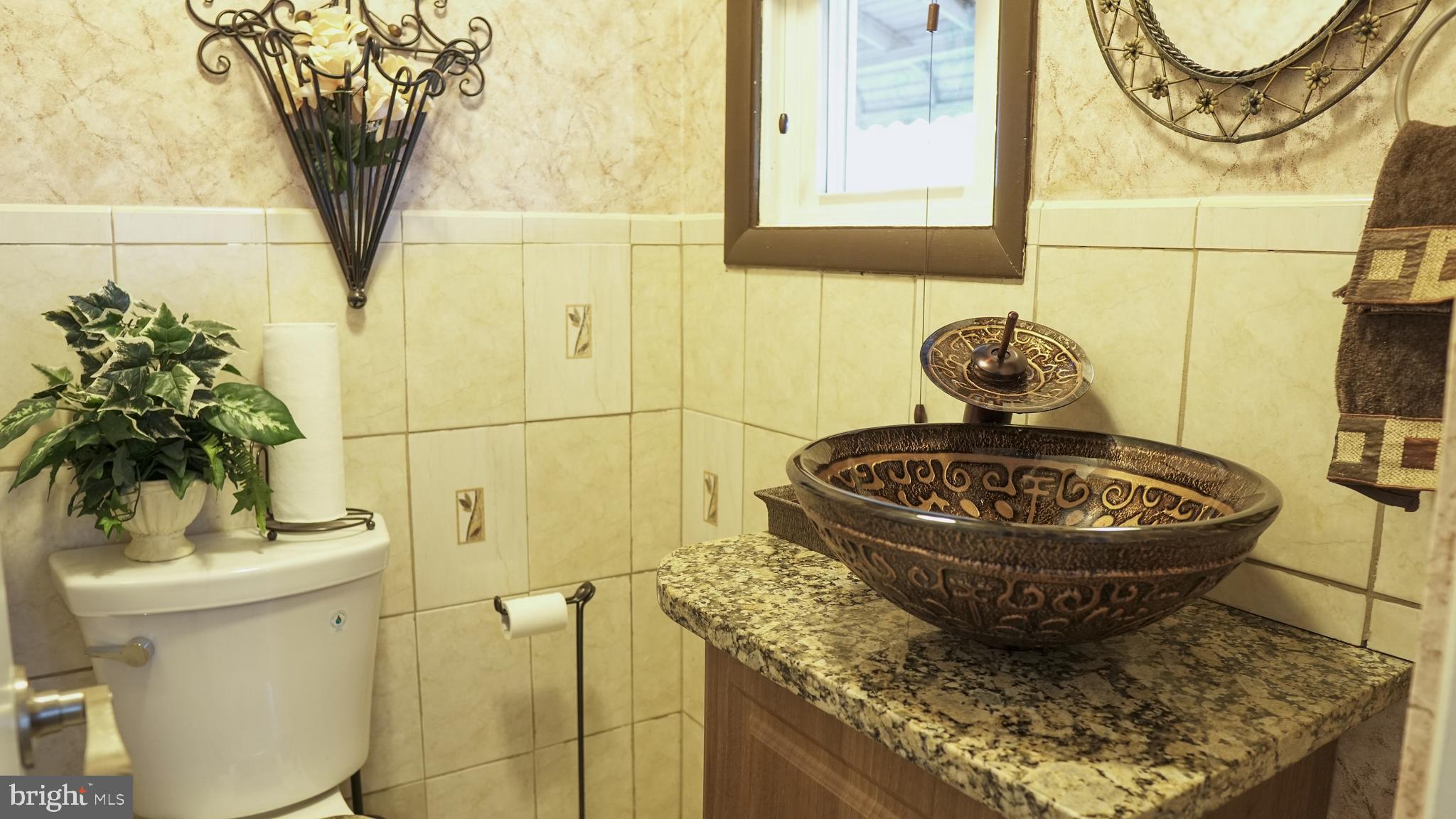 4238 Labyrinth Road Baltimore, MD 21215 - Photo 4 of 20 Half bath on main level, granite countertop