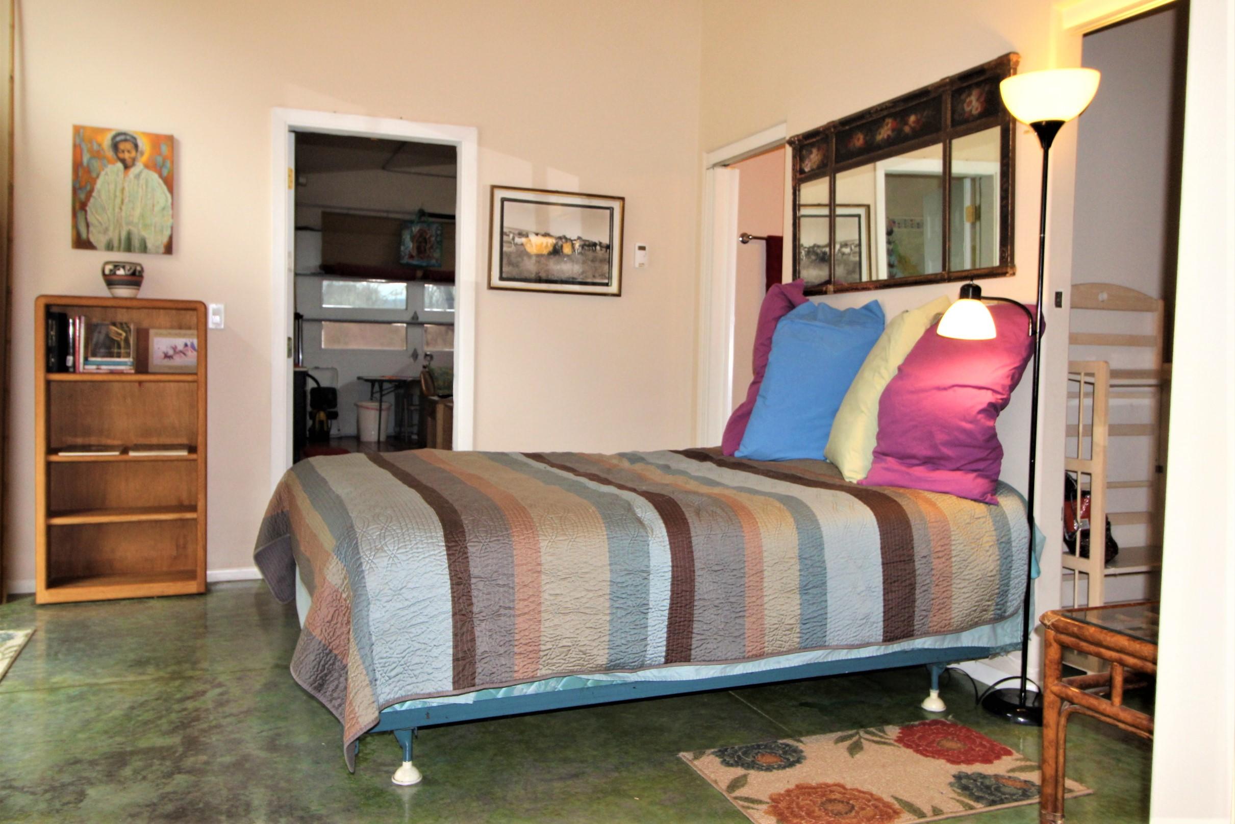 2200 Little Applegate Road Jacksonville, OR 97530 - Photo 20 of 39 a bed sitting in a bedroom next to a window with pc on the wall