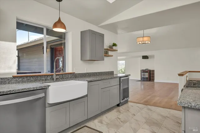 a kitchen with stainless steel appliances granite countertop a refrigerator stove a sink and a microwave