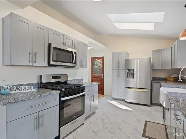 a spacious bedroom with a bed and a dresser