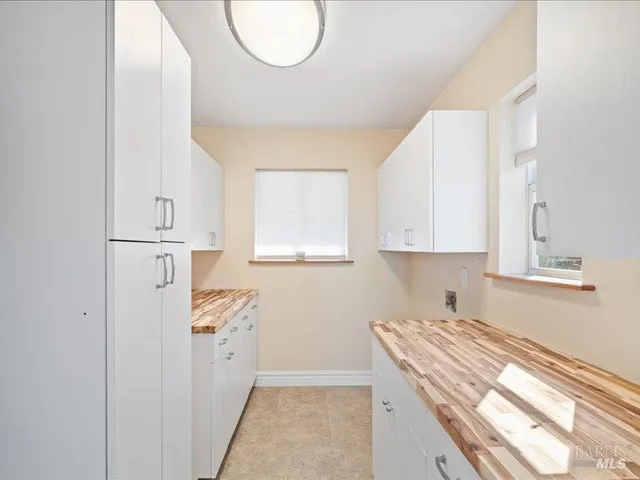 an empty room with windows and closet