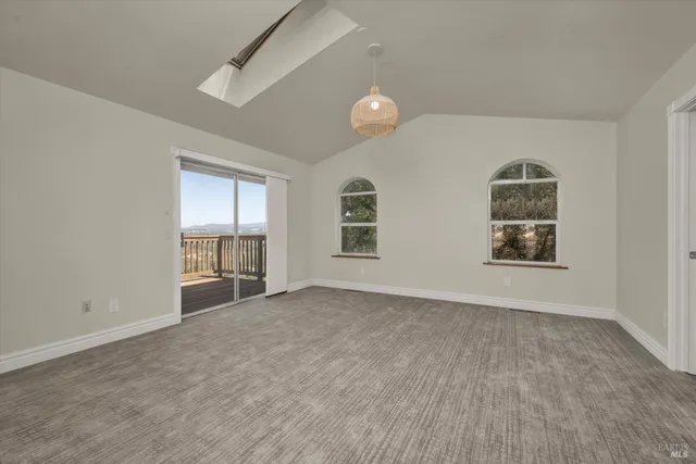 an empty room with windows and cabinet
