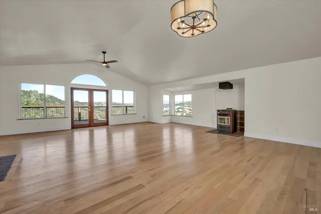 a dining room with wooden floor a glass table and chairs