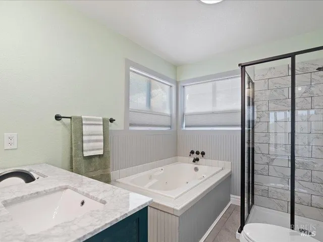 a dining room with wooden floor and a table