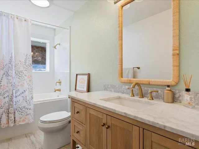 a roof deck with table and chairs and potted plants