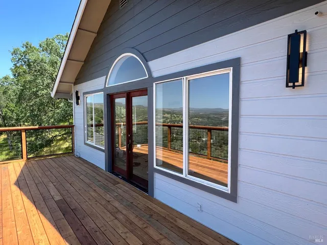 a view of a brick house with a chairs and table in a patio