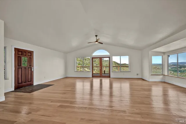 a view of a dining room with furniture large windows and wooden floor