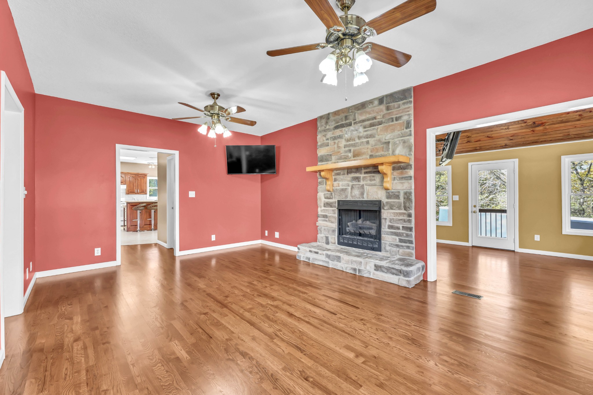 2753 Jarrell Ridge Road Clarksville, TN 37043 - Photo 12 of 80 a view of an empty room with chandelier fan and wooden floor