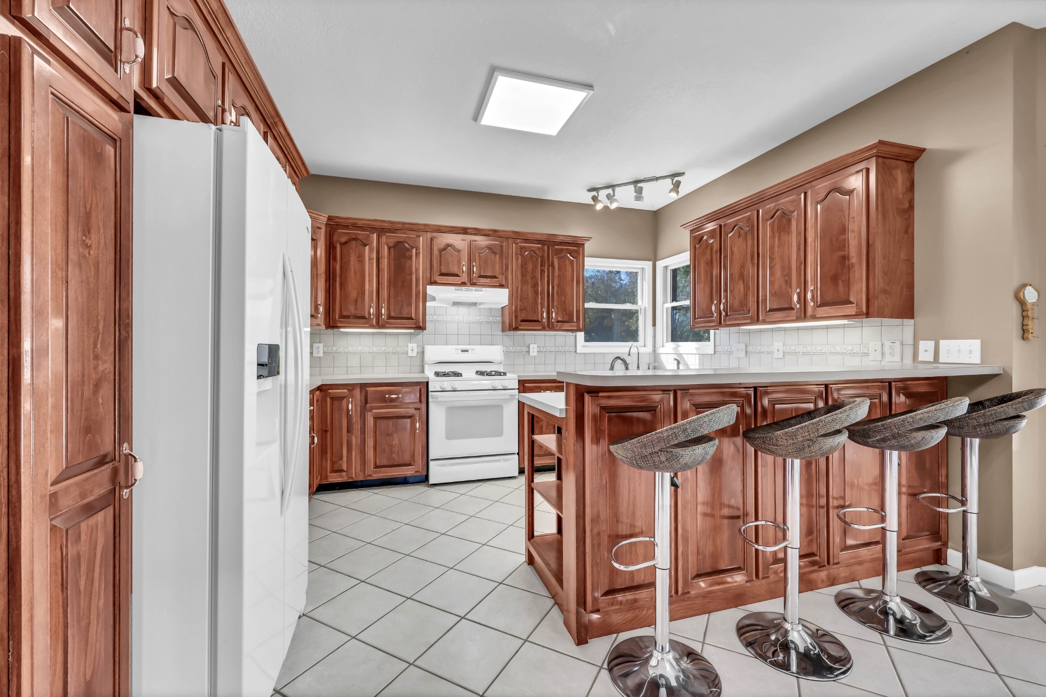2753 Jarrell Ridge Road Clarksville, TN 37043 - Photo 17 of 80 a kitchen with stainless steel appliances granite countertop a stove a sink dishwasher and a refrigerator with wooden cabinets