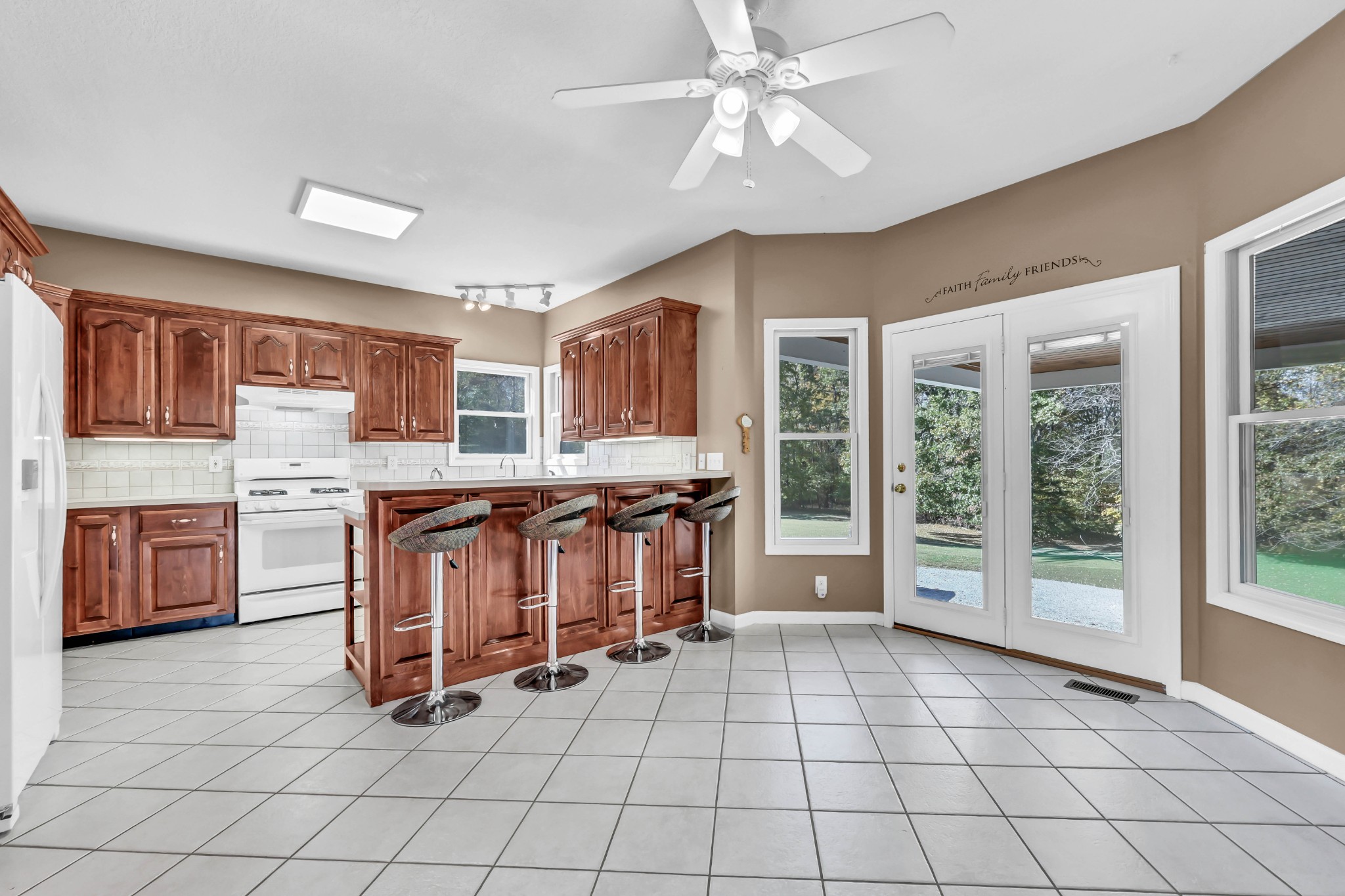 2753 Jarrell Ridge Road Clarksville, TN 37043 - Photo 19 of 80 a view of a kitchen with granite countertop a stove a sink dishwasher a dining table and chair with a large window