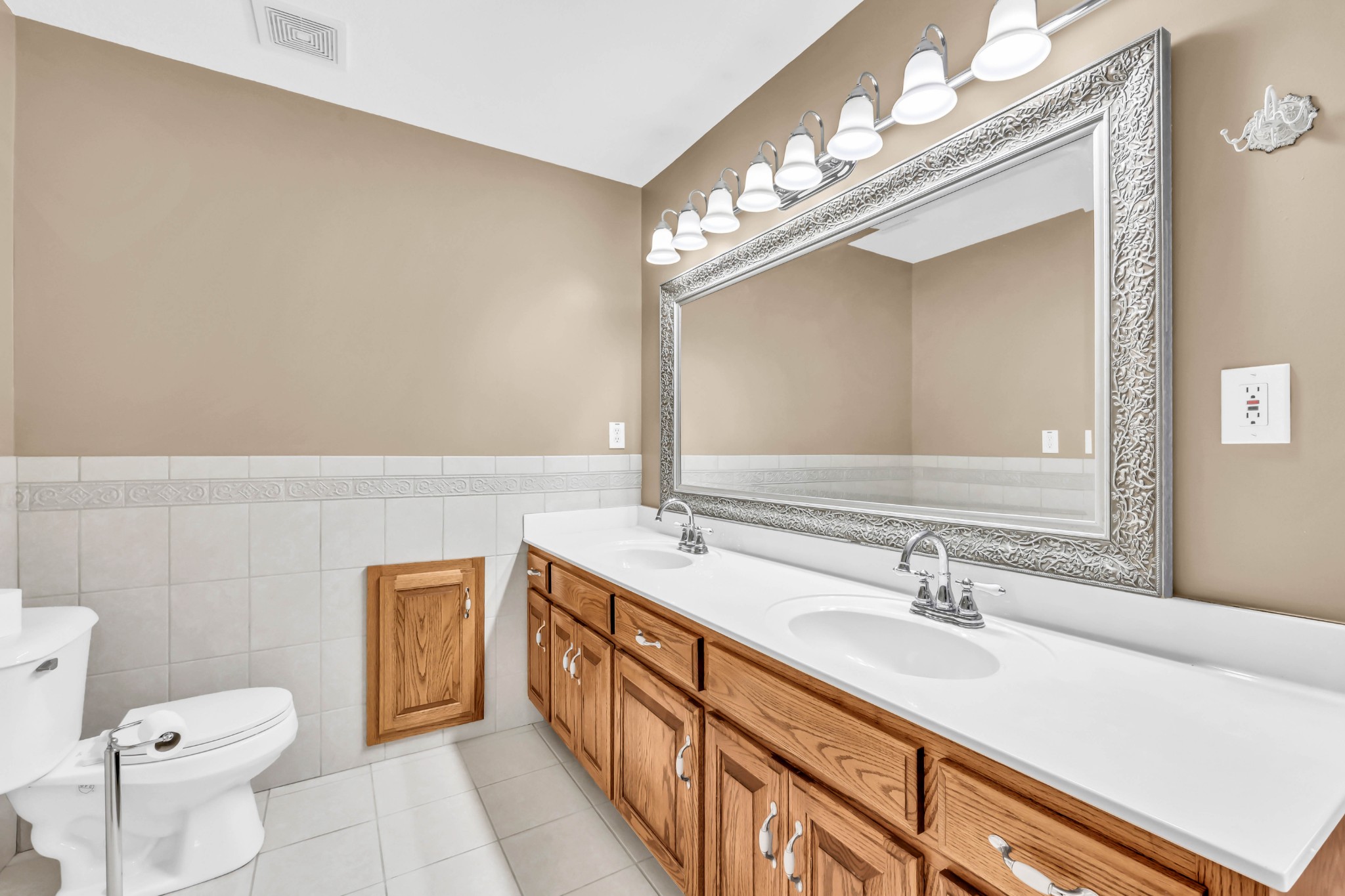 2753 Jarrell Ridge Road Clarksville, TN 37043 - Photo 26 of 80 a bathroom with a sink a toilet a mirror and vanity