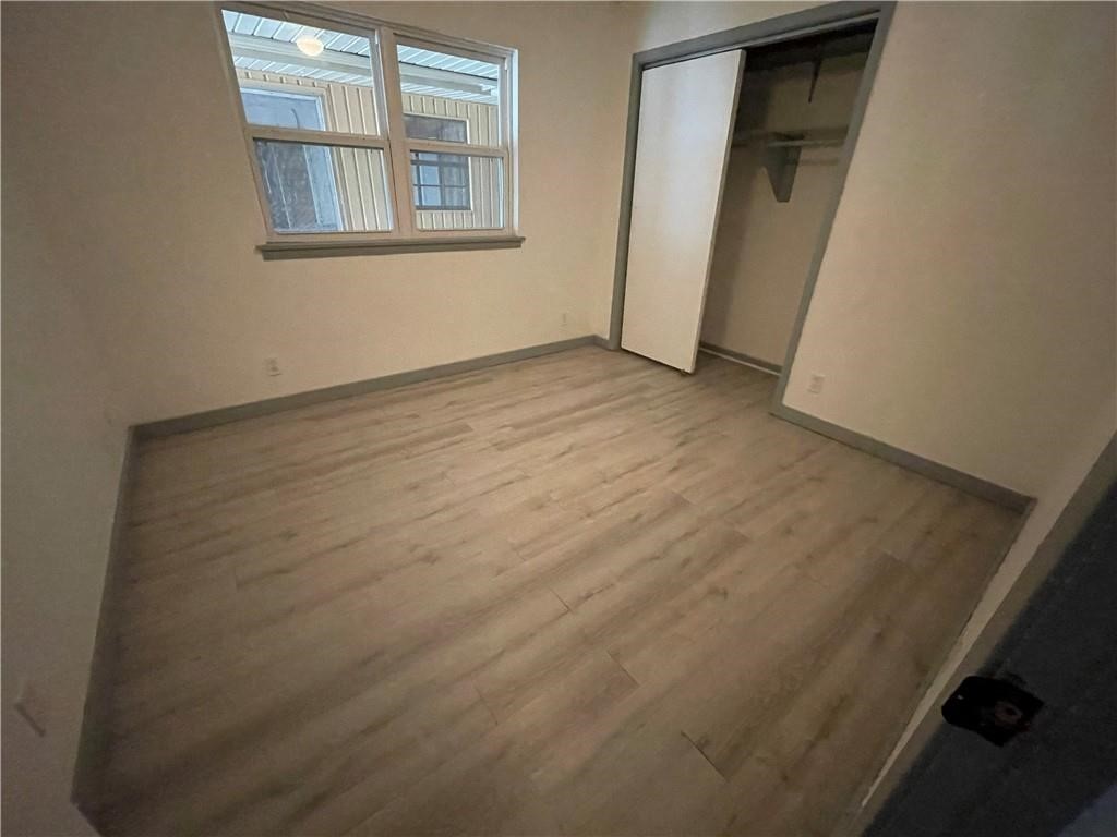 133 Fulton Place Portland, TX 78374 - Photo 11 of 13 an empty room with wooden floor and windows