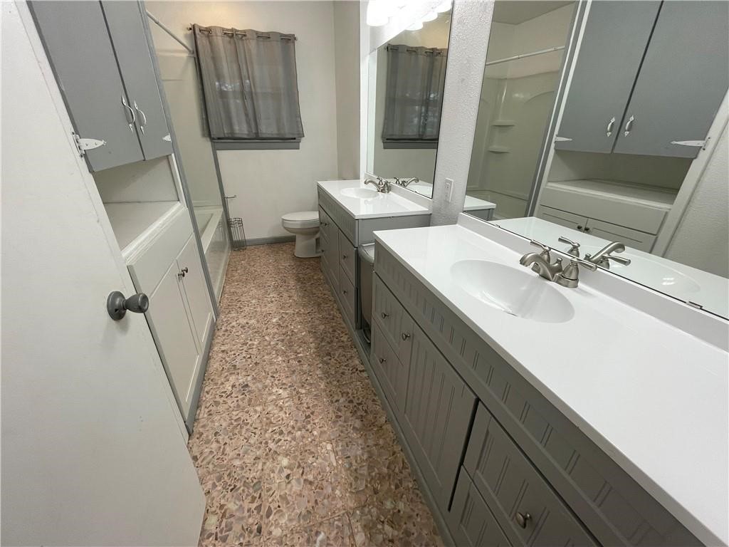 133 Fulton Place Portland, TX 78374 - Photo 13 of 13 a bathroom with a double vanity sink and mirror