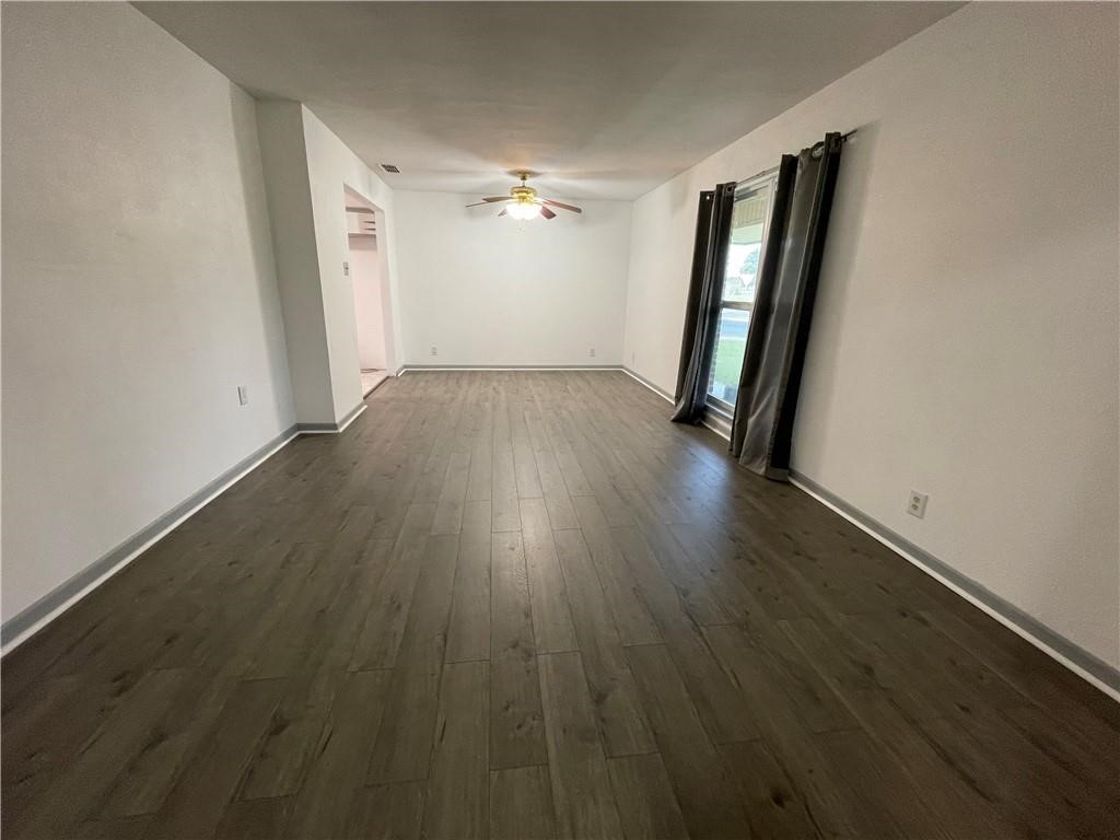 133 Fulton Place Portland, TX 78374 - Photo 2 of 13 an empty room with wooden floor and staircase