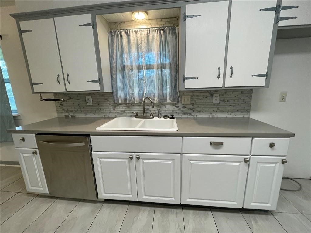 133 Fulton Place Portland, TX 78374 - Photo 5 of 13 a kitchen with white cabinets and white appliances