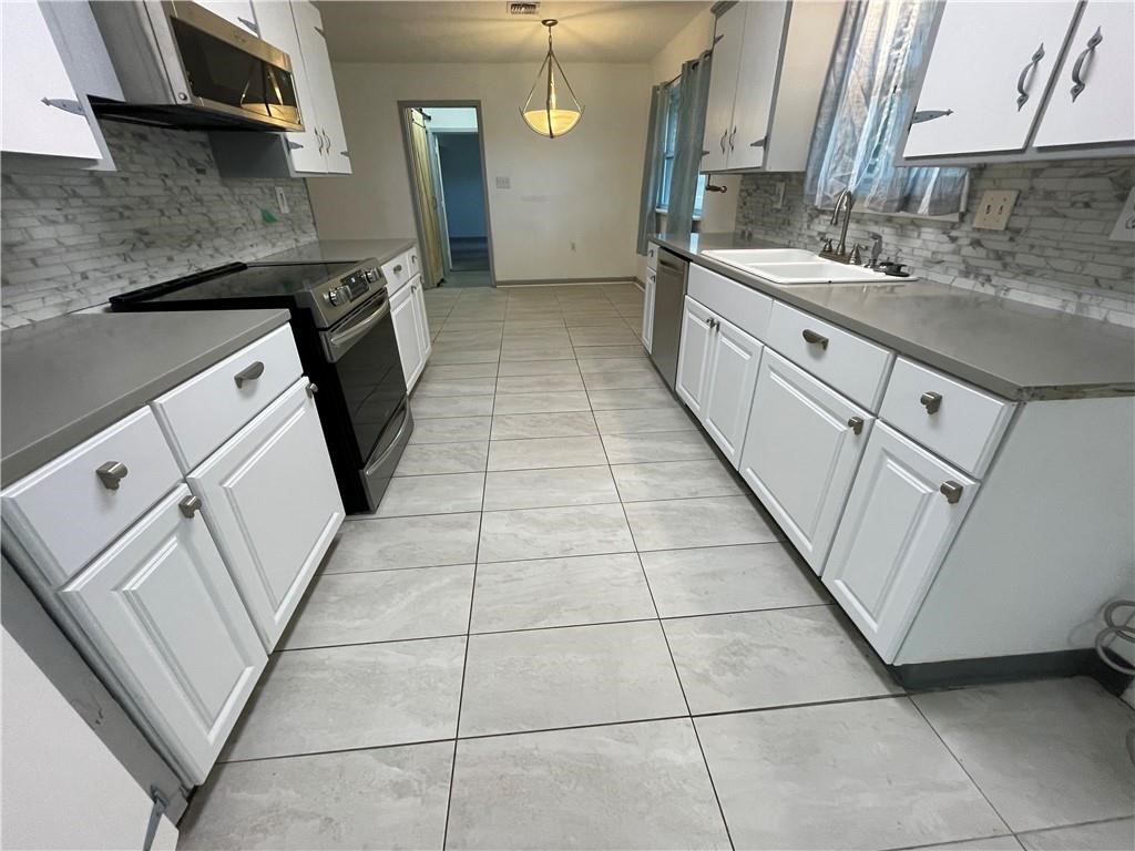 133 Fulton Place Portland, TX 78374 - Photo 6 of 13 a kitchen with a sink a stove and a refrigerator
