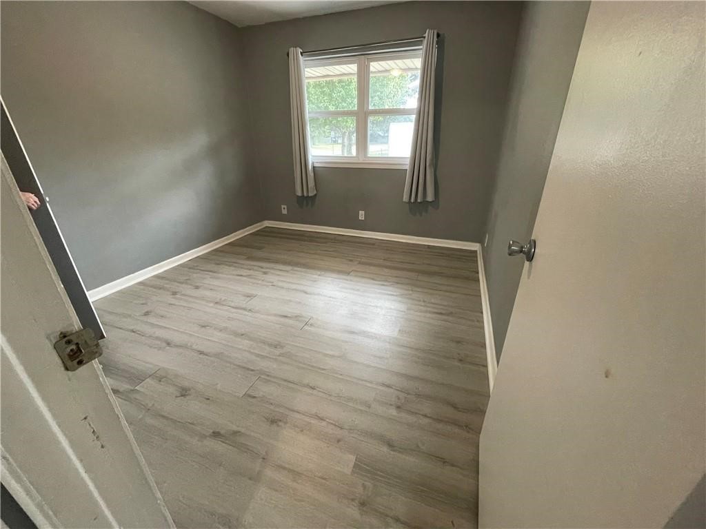 133 Fulton Place Portland, TX 78374 - Photo 10 of 13 an empty room with wooden floor and windows