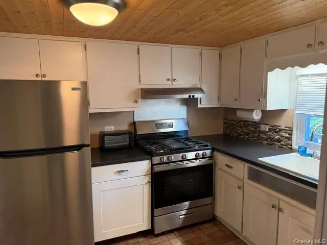 a view of an empty room and wooden floor