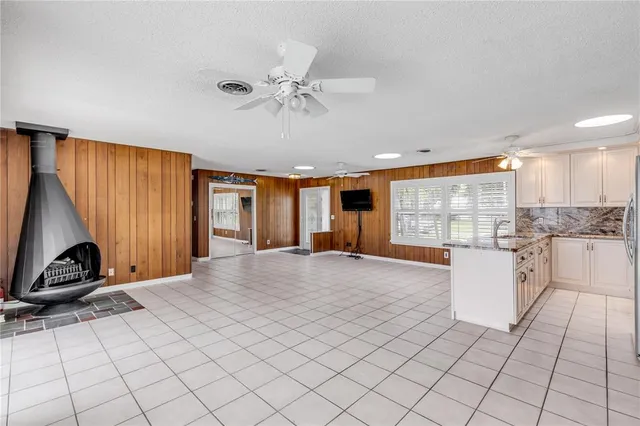 a kitchen with stainless steel appliances granite countertop a sink refrigerator stove and microwave