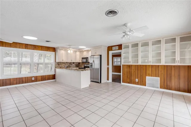 a bathroom with a granite countertop sink toilet a large mirror and shower