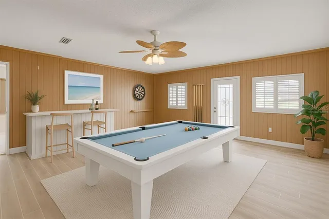 a swimming pool with plants and large trees