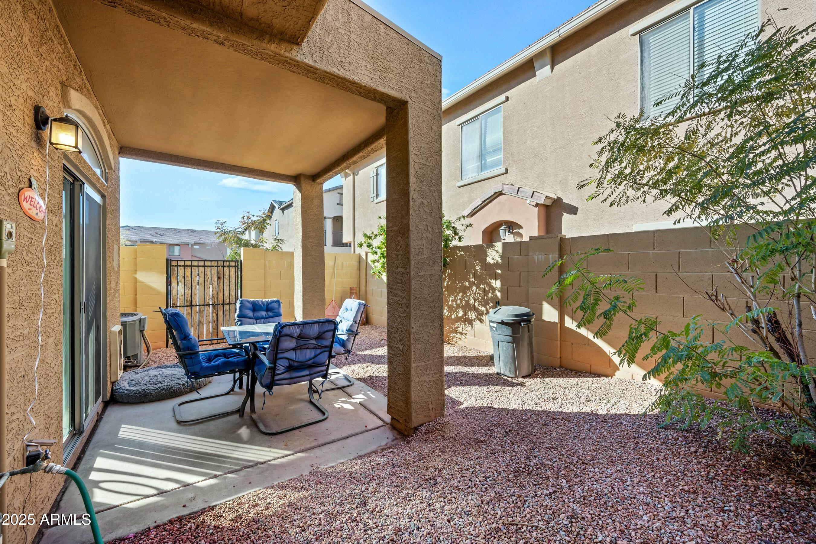 2150 East Bell Road, Unit 1130 Phoenix, AZ 85022 - Photo 12 of 39 a view of a patio with table and chairs near a barbeque