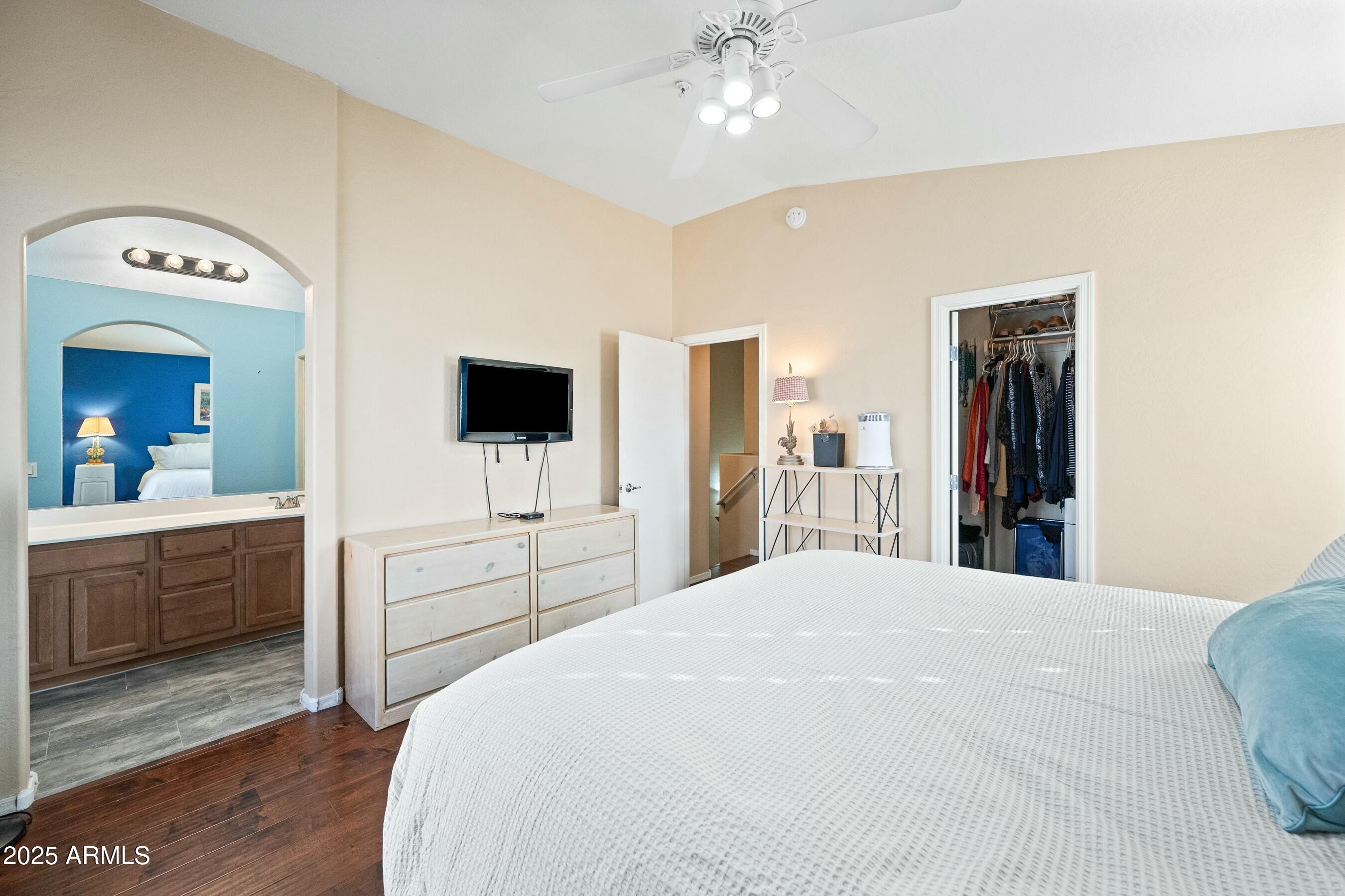 2150 East Bell Road, Unit 1130 Phoenix, AZ 85022 - Photo 21 of 39 a bedroom with a large bed and flat tv screen on dresser