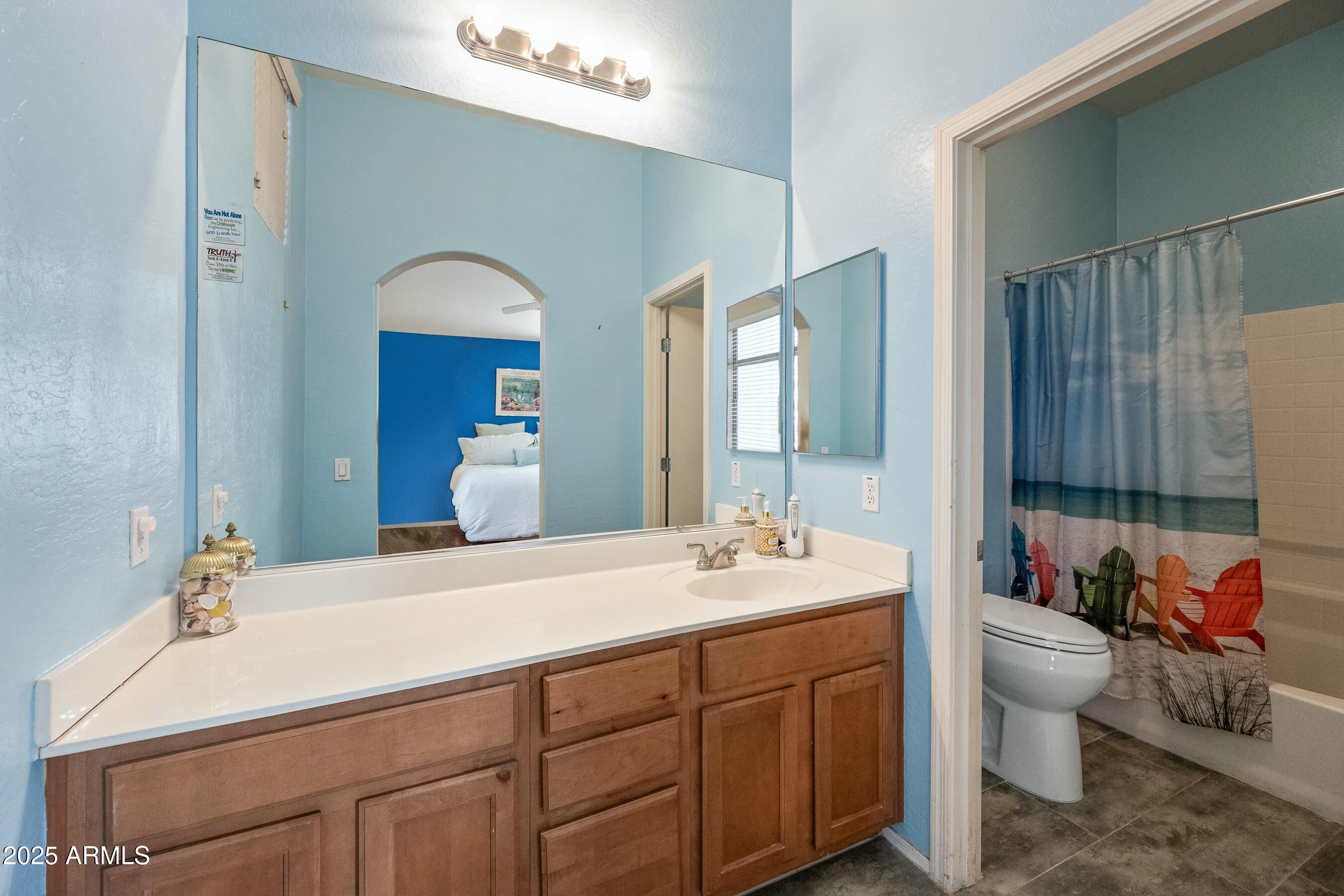 2150 East Bell Road, Unit 1130 Phoenix, AZ 85022 - Photo 22 of 39 a bathroom with a double vanity sink mirror and toilet