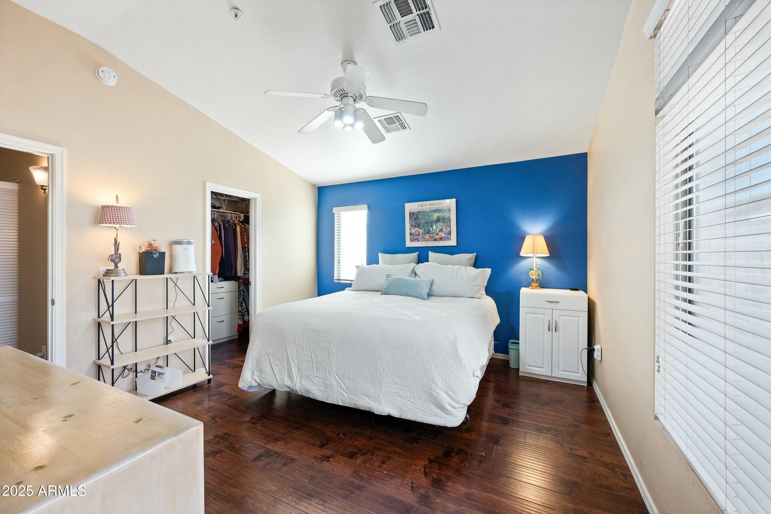 2150 East Bell Road, Unit 1130 Phoenix, AZ 85022 - Photo 23 of 39 a bedroom with a bed and a chandelier