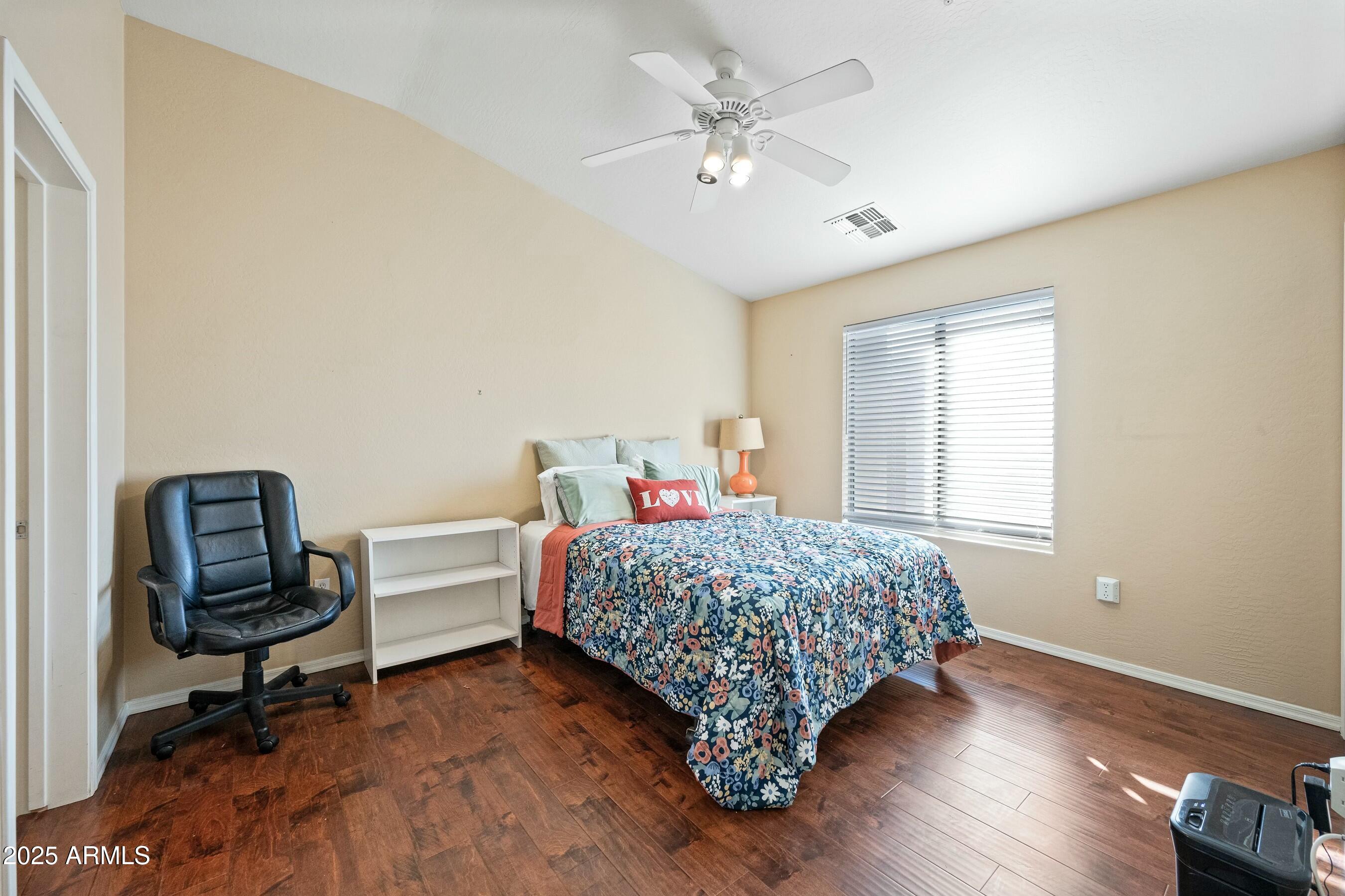 2150 East Bell Road, Unit 1130 Phoenix, AZ 85022 - Photo 25 of 39 a bedroom with a bed a desk and chair