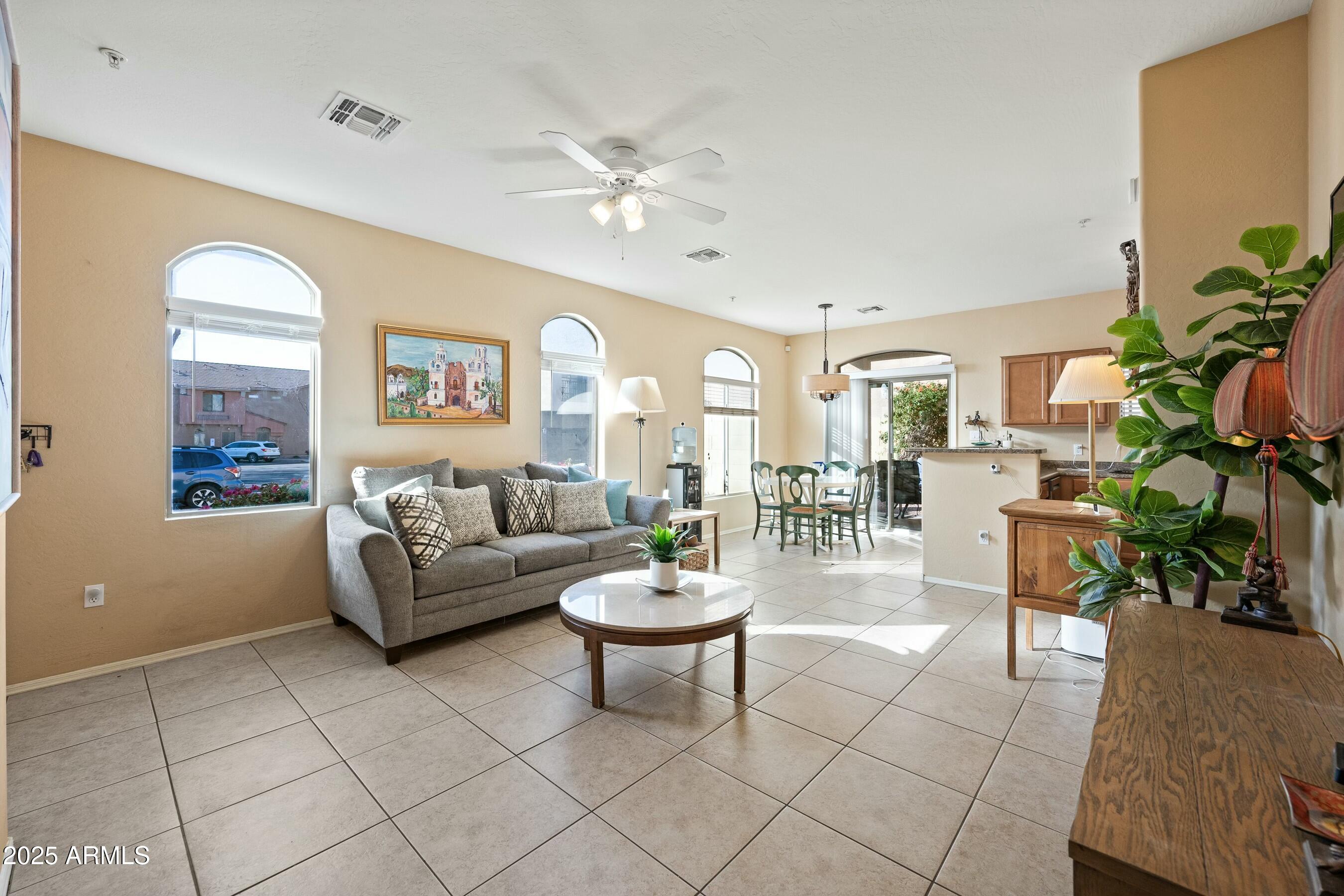2150 East Bell Road, Unit 1130 Phoenix, AZ 85022 - Photo 4 of 39 a living room with fireplace furniture and a potted plant