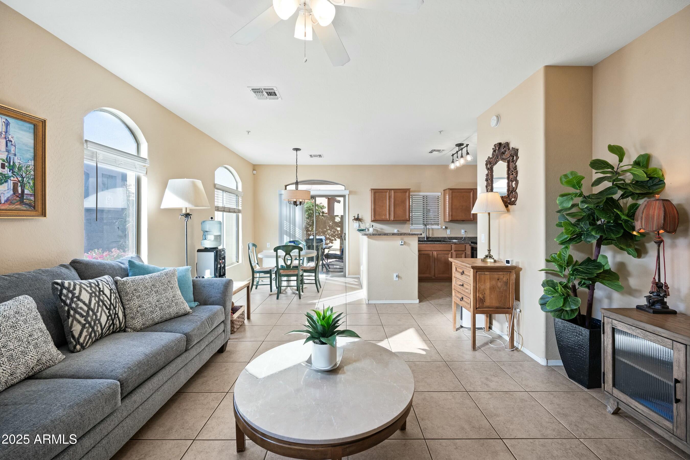 2150 East Bell Road, Unit 1130 Phoenix, AZ 85022 - Photo 38 of 39 a living room with furniture kitchen and a chandelier