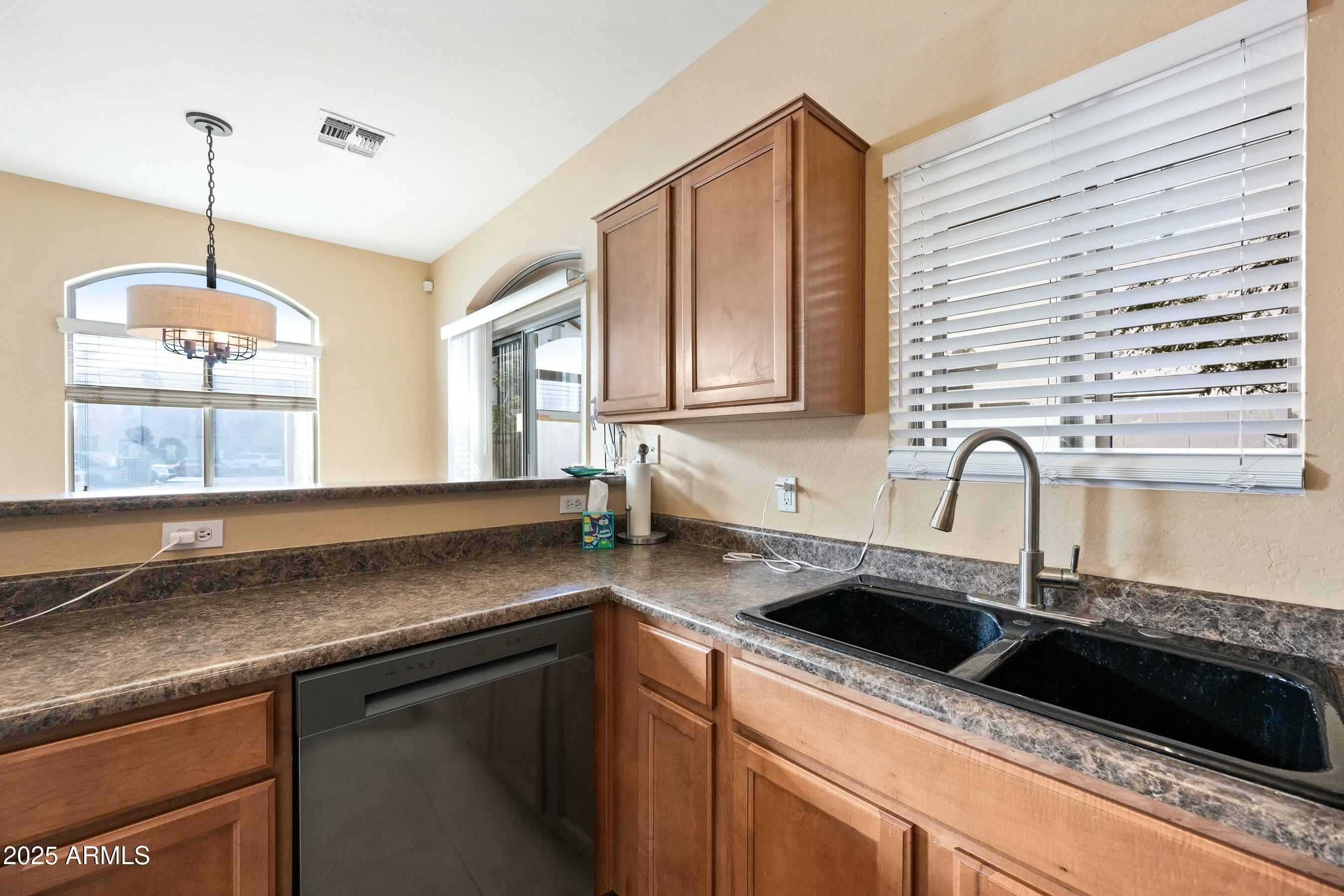 2150 East Bell Road, Unit 1130 Phoenix, AZ 85022 - Photo 9 of 39 a kitchen with granite countertop a sink and a stove