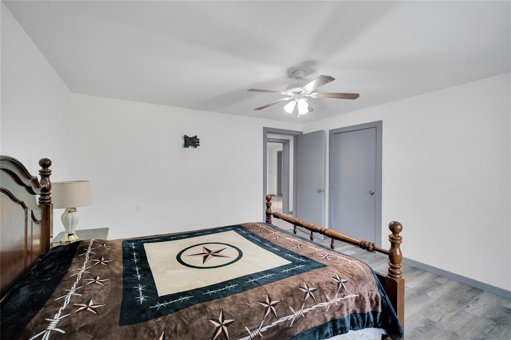 10476 County Road 313 Terrell, TX 75161 - Photo 17 of 40 a bedroom with a bed and a chandelier