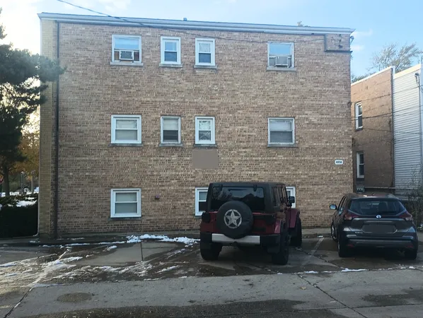 a car parked in front of a brick building