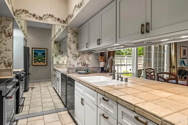 a kitchen with stainless steel appliances a sink stove and cabinets