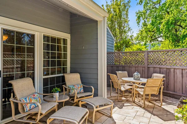 a view of a chairs and table in patio with potted plants