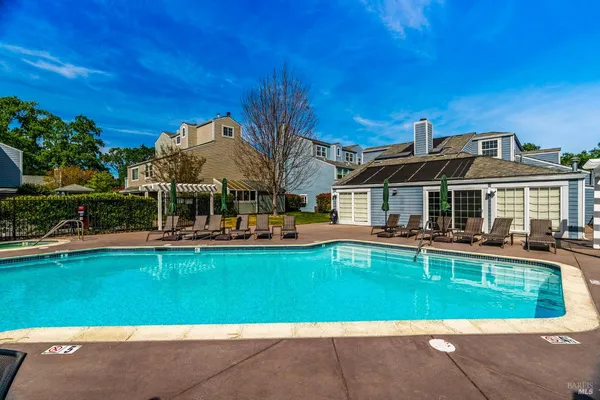 a front view of house with swimming pool having outdoor seating