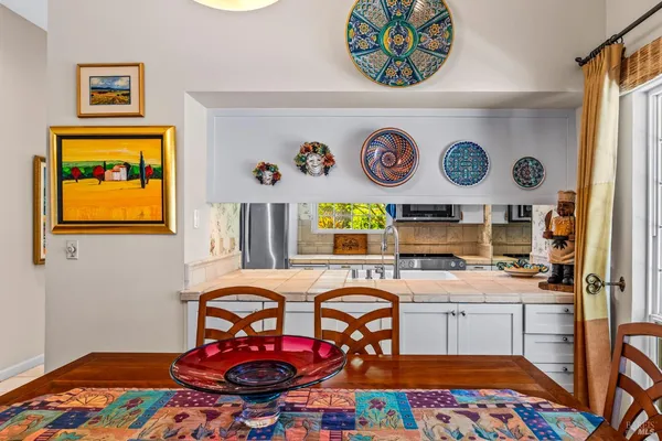 a room with furniture and paintings on the wall