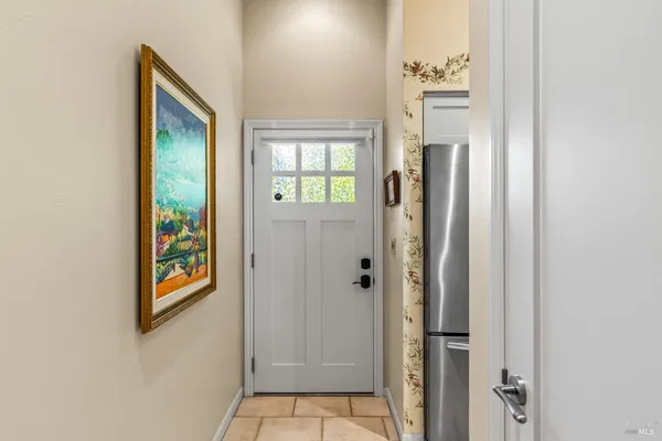 a view of a hallway with windows and entryway