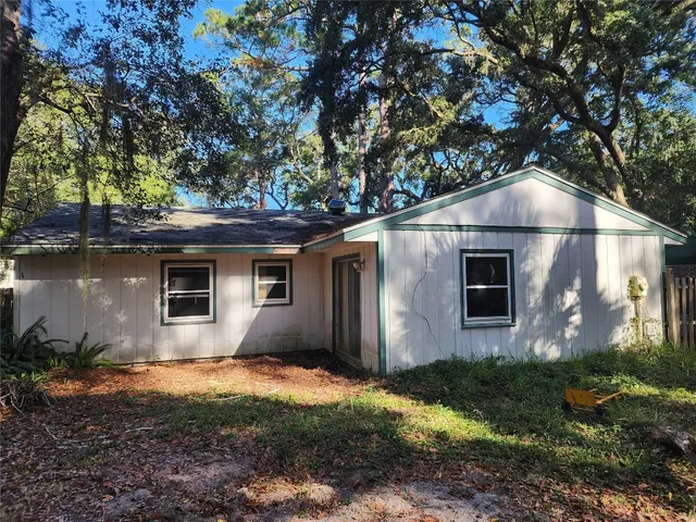 a house with trees in the background