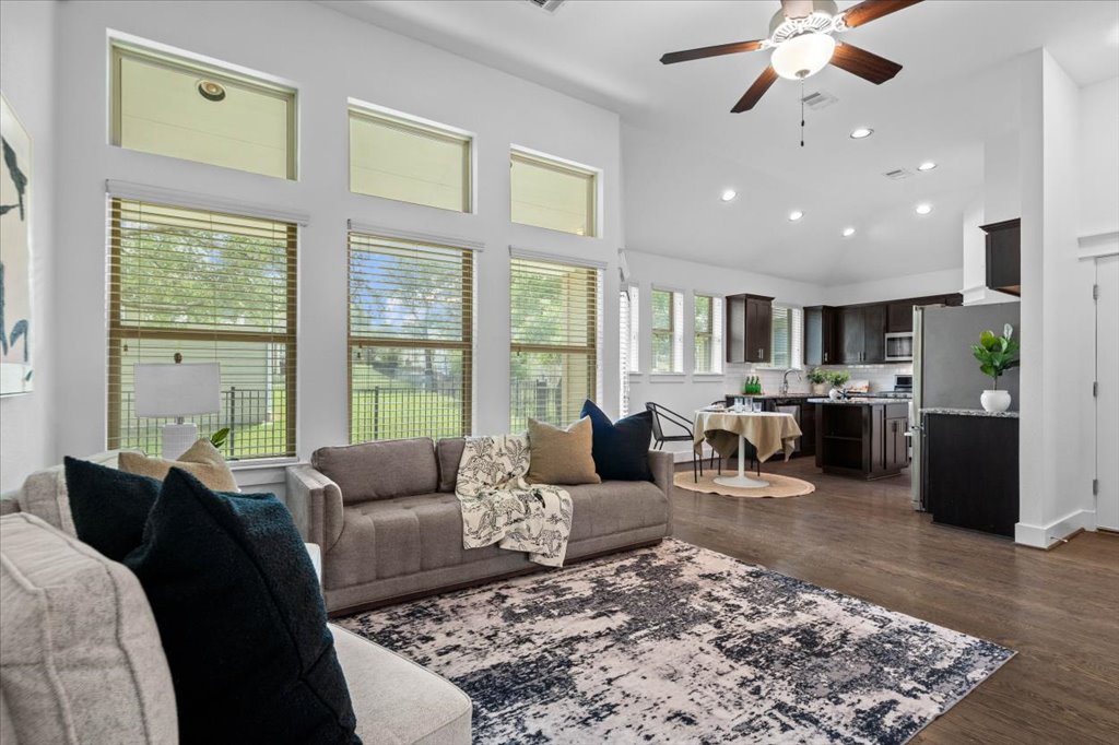 Soaring ceilings and tall windows frame this light-filled open concept living area and kitchen.