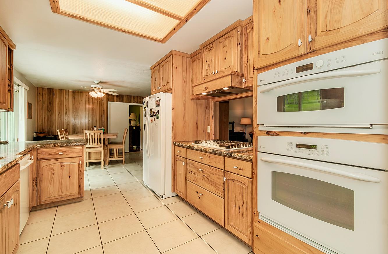 29979 Post Oak Road Tollhouse, CA 93667 - Photo 15 of 42 a kitchen with stainless steel appliances granite countertop a stove a sink and a refrigerator